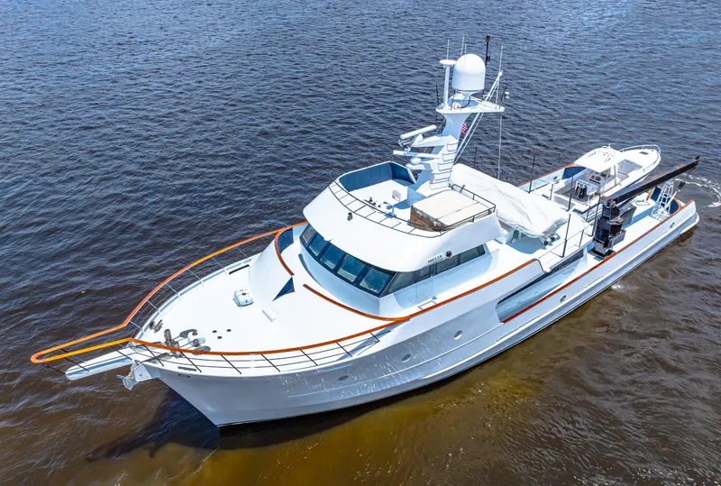 Slide: The Image of 1991 Expedition Freeport Yachts on water, aerial view, sleek white design. - 18