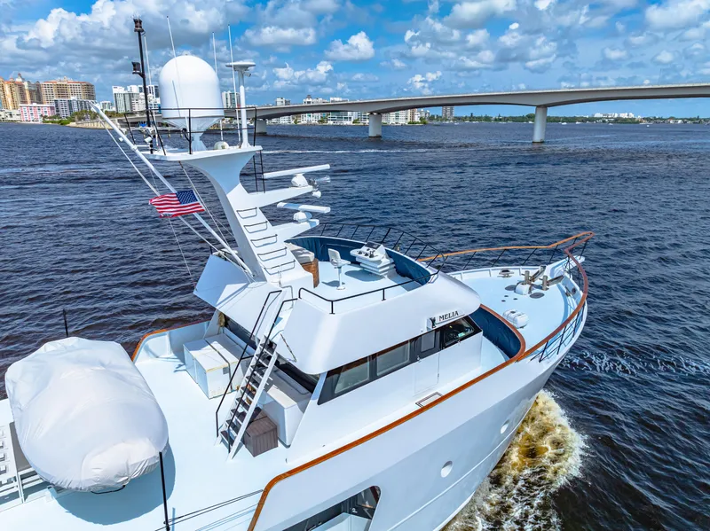 Slide: The Image of Expedition Freeport Yachts 1991 cruising under a bridge on a sunny day. - 19