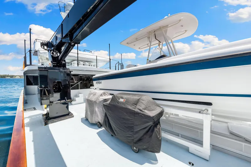 Slide: The Image of 1991 Expedition Freeport Yachts deck with covered equipment and crane under blue sky. - 23