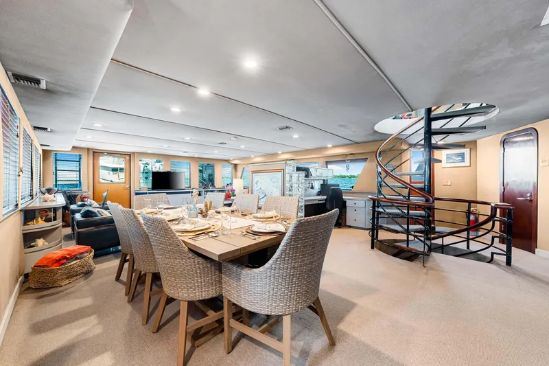 Slide: The Image of Luxurious 1991 Expedition Freeport Yachts interior with dining area and spiral staircase. - 42