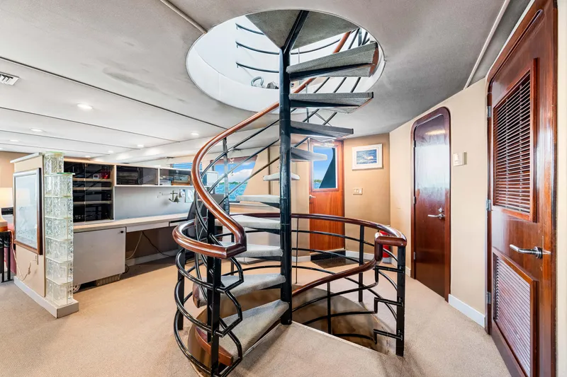 Slide: The Image of Spiral staircase in 1991 Expedition Freeport Yachts interior, featuring modern design and wood accents. - 44