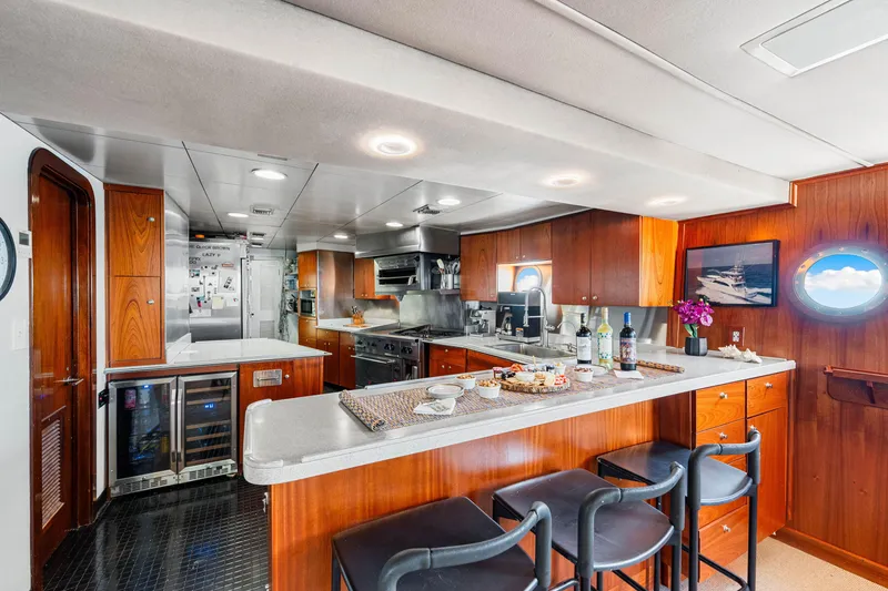 Slide: The Image of Luxurious 1991 Expedition Freeport Yachts kitchen with modern amenities and elegant wood finishes. - 47