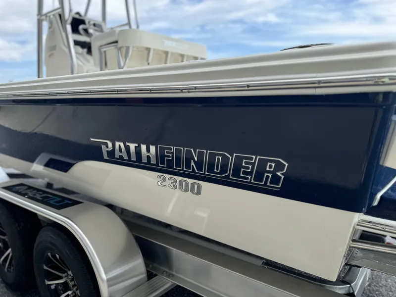 Slide: The Image of 2025 Pathfinder 2300 HPS boat on trailer, side view with logo. - 12
