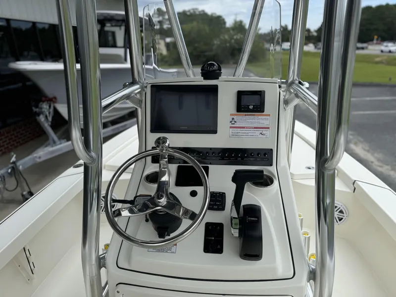 Slide: The Image of 2025 Pathfinder 2300 HPS boat console with steering wheel and navigation controls. - 16