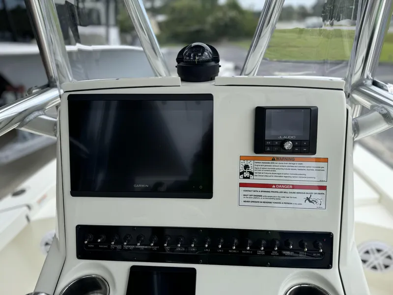 Slide: The Image of 2025 Pathfinder 2300 HPS boat dashboard with navigation screens and controls. - 17