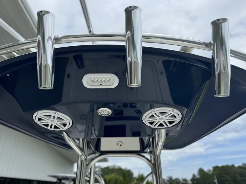 Slide: The Image of 2025 Pathfinder 2300 HPS boat T-top with rod holders and speakers. - 19
