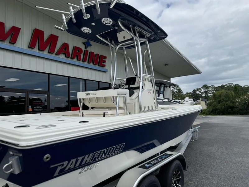 Slide: The Image of 2025 Pathfinder 2300 HPS boat displayed outside marine dealership. - 3