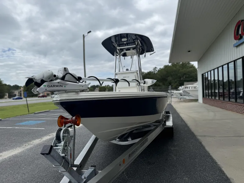 Slide: The Image of 2025 Pathfinder 2300 HPS boat on trailer, parked outside a building. - 5