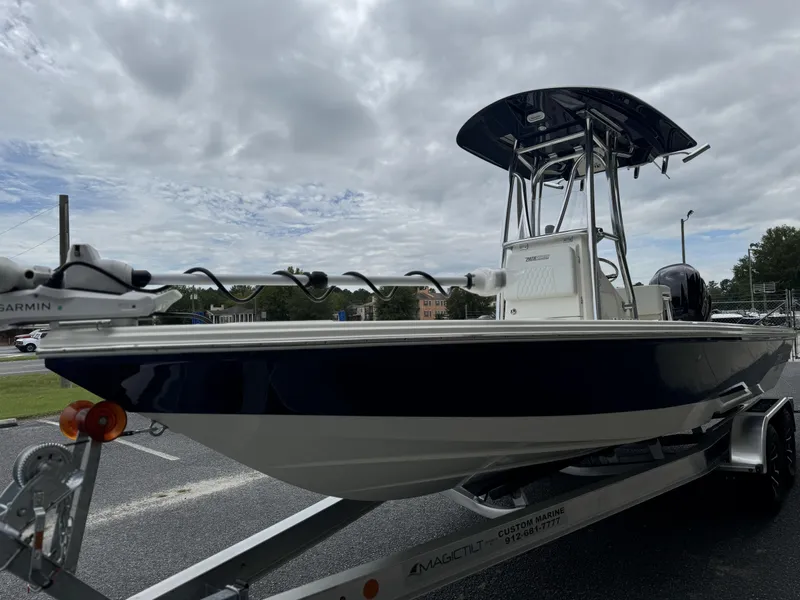 Slide: The Image of 2025 Pathfinder 2300 HPS boat on trailer under cloudy sky. - 6