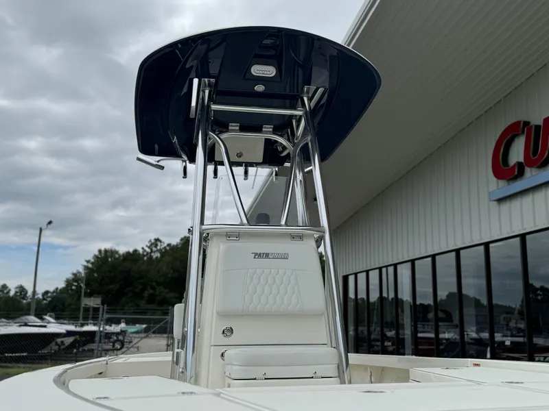 Slide: The Image of 2025 Pathfinder 2300 HPS boat with T-top, displayed outdoors near a dealership. - 8