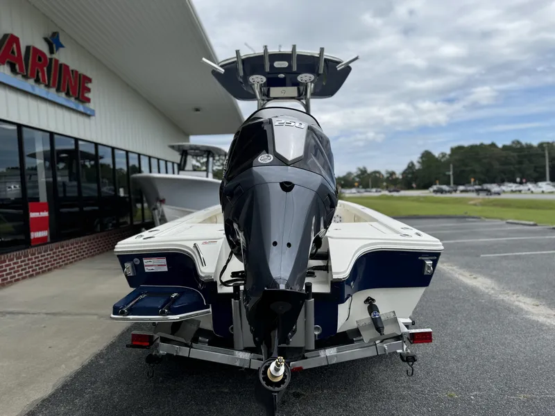 Slide: The Image of 2025 Pathfinder 2300 HPS boat on trailer outside marine dealership. - 9