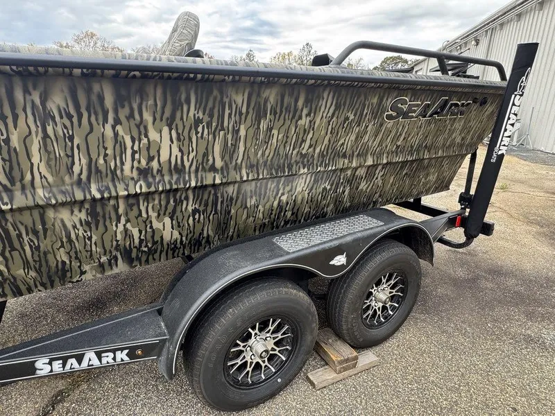 Slide: The Image of 2025 SeaArk Predator boat cockpit with steering wheel and comfortable seating. - 12