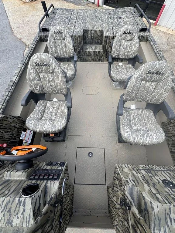 Slide: The Image of 2025 SeaArk Predator boat cockpit with steering wheel and control panel. - 18