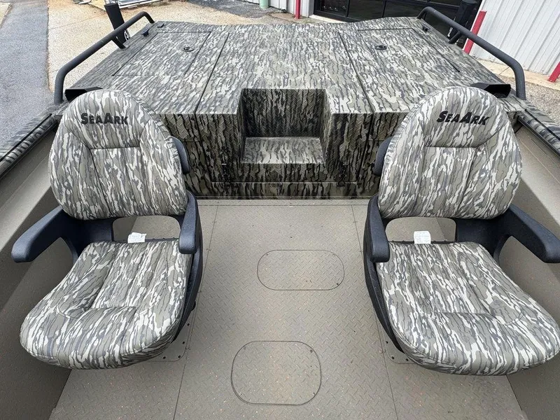 Slide: The Image of 2025 SeaArk Predator boat interior with two cushioned seats and storage area. - 20