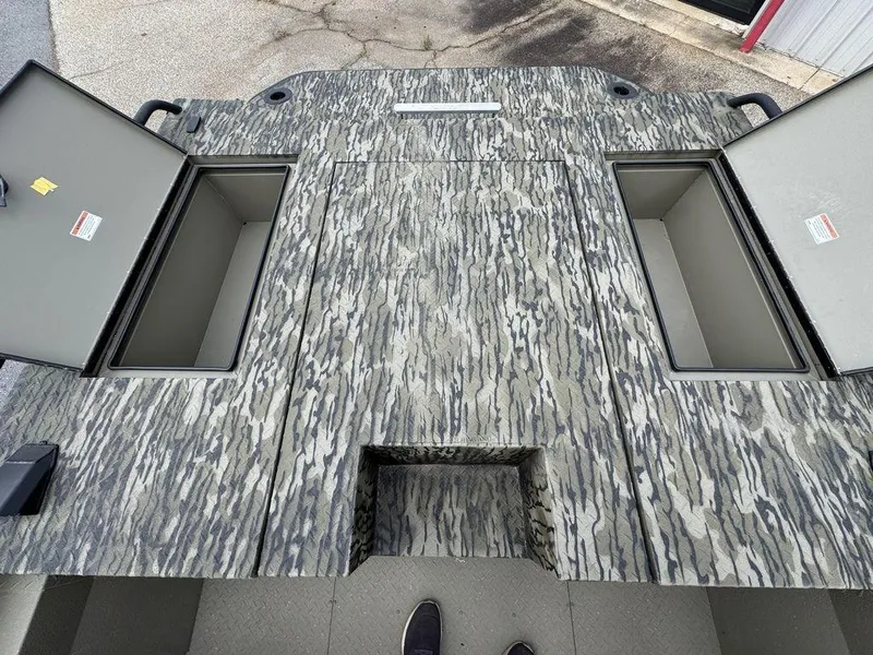 Slide: The Image of 2025 SeaArk Predator boat deck with storage compartments and shadow. - 21