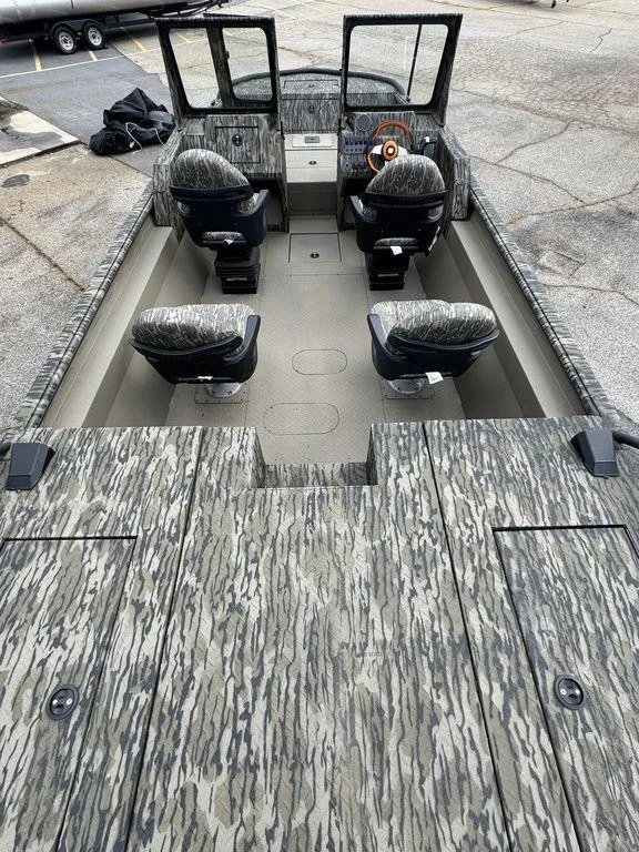 Slide: The Image of Open storage compartment on 2025 SeaArk Predator boat, featuring a secure latch and spacious interior. - 22