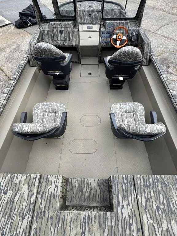 Slide: The Image of Open storage compartment on 2025 SeaArk Predator boat, showing interior and documents. - 23