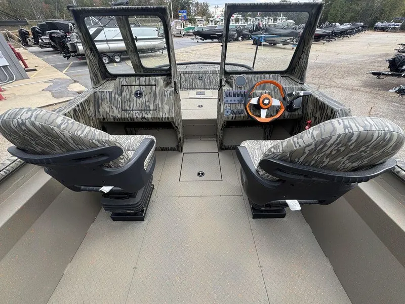 Slide: The Image of 2025 SeaArk Predator boat interior with four seats and steering console. - 25