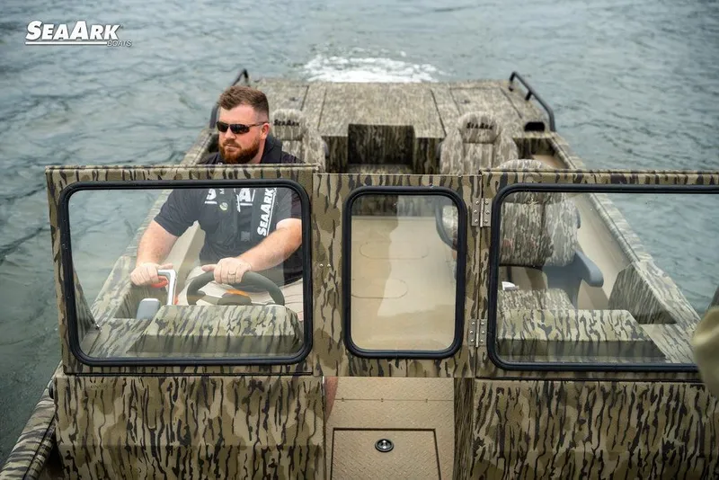 Slide: The Image of 2025 SeaArk Predator boat on water, featuring camouflage design and dual windshields. - 31