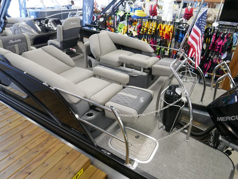 Slide: The Image of 2024 Barletta Lusso 23M luxury pontoon boat interior with plush seating and American flag. - 44