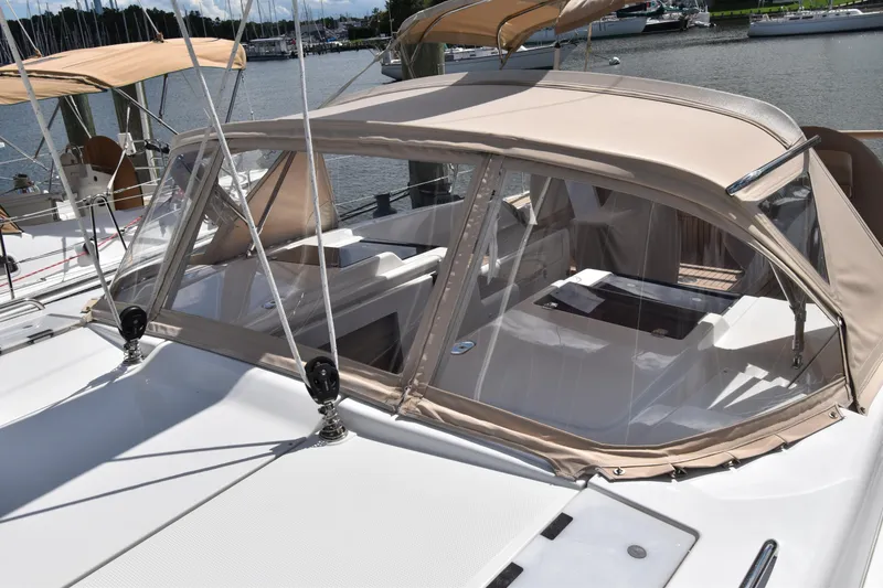 Slide: The Image of 2019 Hanse 458 yacht with beige canopy docked at marina. - 13