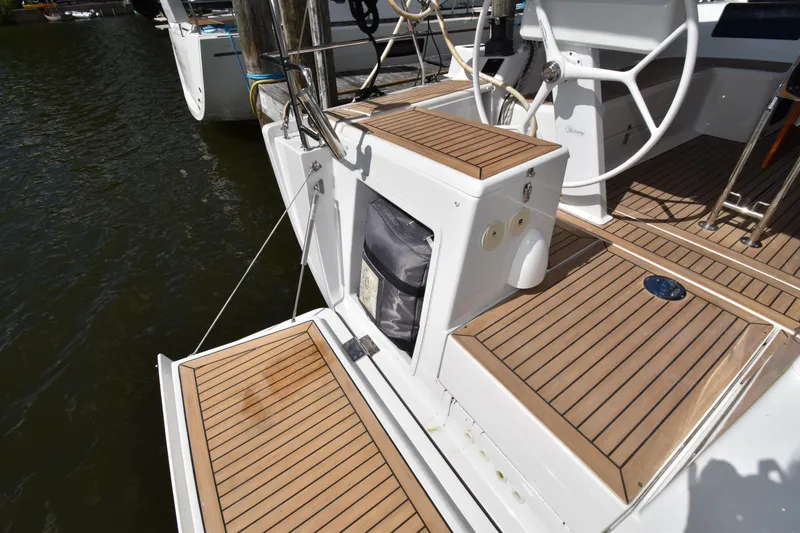 Slide: The Image of 2019 Hanse 458 yacht deck with wooden flooring and steering wheel. - 19