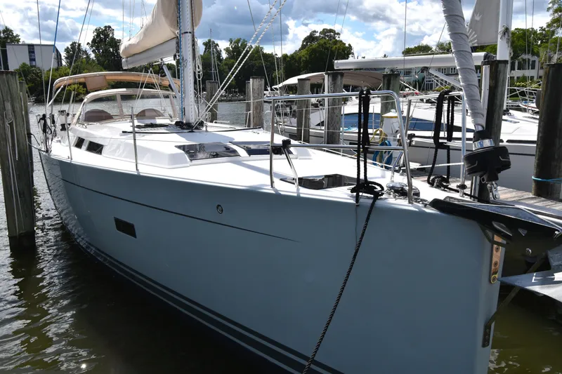 Slide: The Image of 2019 Hanse 458 yacht docked at marina, featuring sleek design and modern sails. - 2