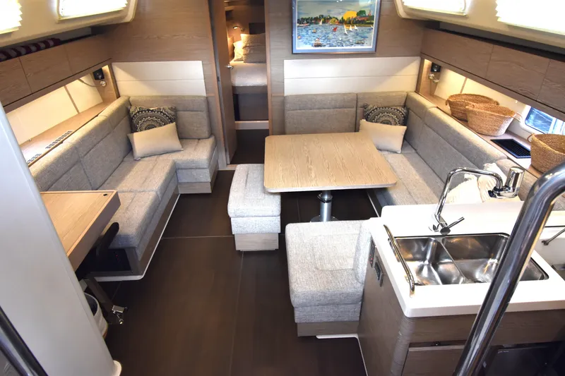 Slide: The Image of Interior of 2019 Hanse 458 yacht with modern seating and kitchen area. - 3