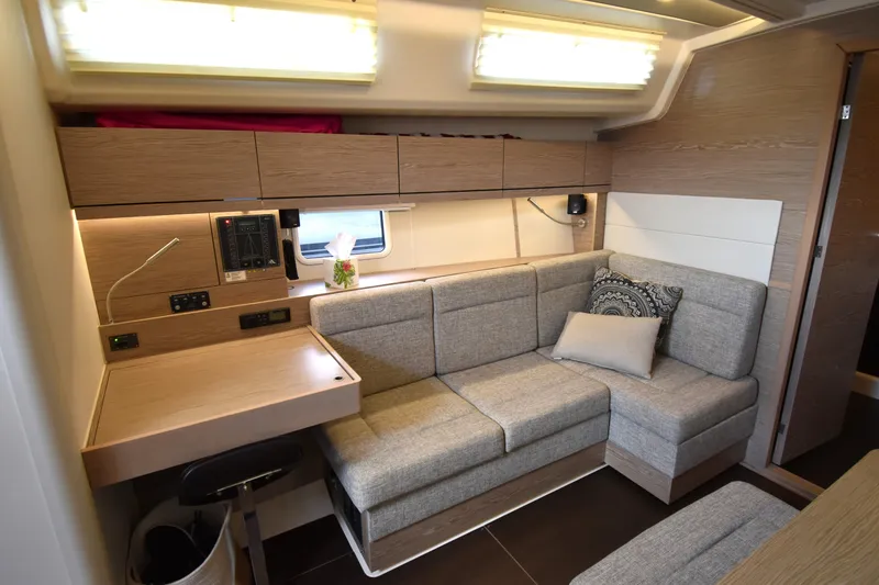 Slide: The Image of Modern interior of 2019 Hanse 458 yacht with cozy seating and desk area. - 31