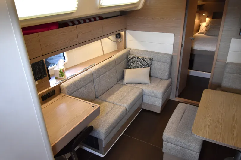 Slide: The Image of Modern interior of 2019 Hanse 458 yacht with cozy seating and wooden accents. - 32