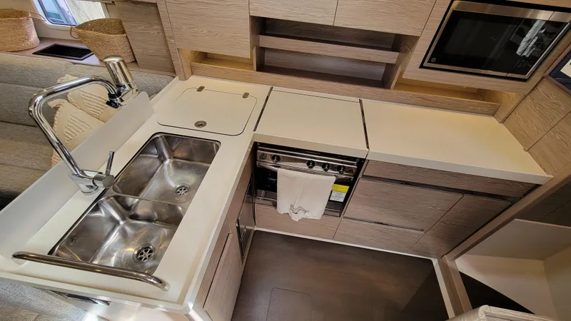 Slide: The Image of Modern kitchen in 2019 Hanse 458 yacht with dual sinks and sleek cabinetry. - 36