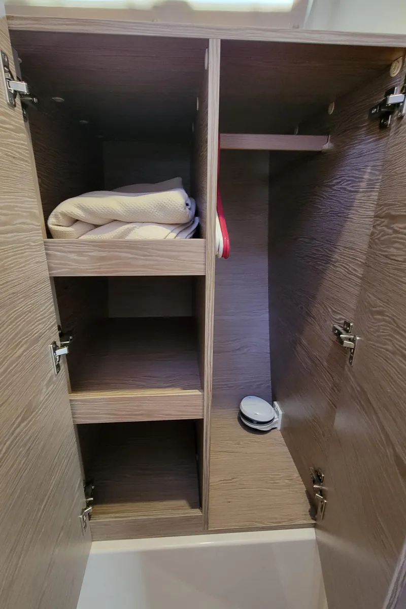 Slide: The Image of Open wooden cabinet with shelves in a 2019 Hanse 458 yacht. - 42