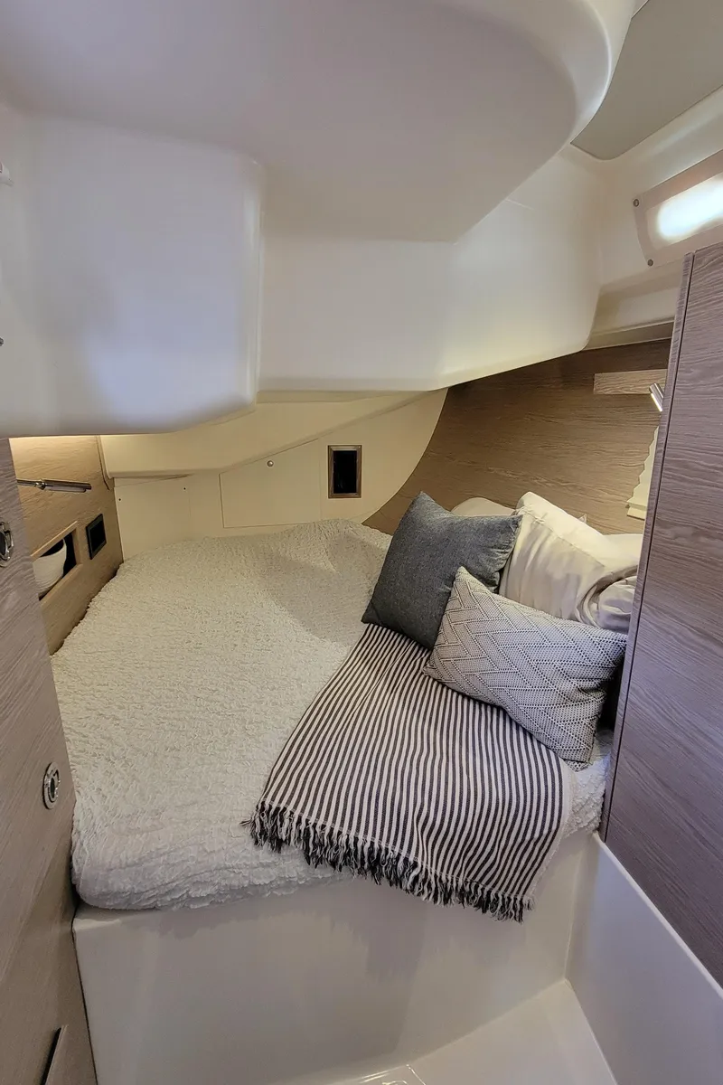 Slide: The Image of Cozy cabin interior of 2019 Hanse 458 yacht with bed and cushions. - 44