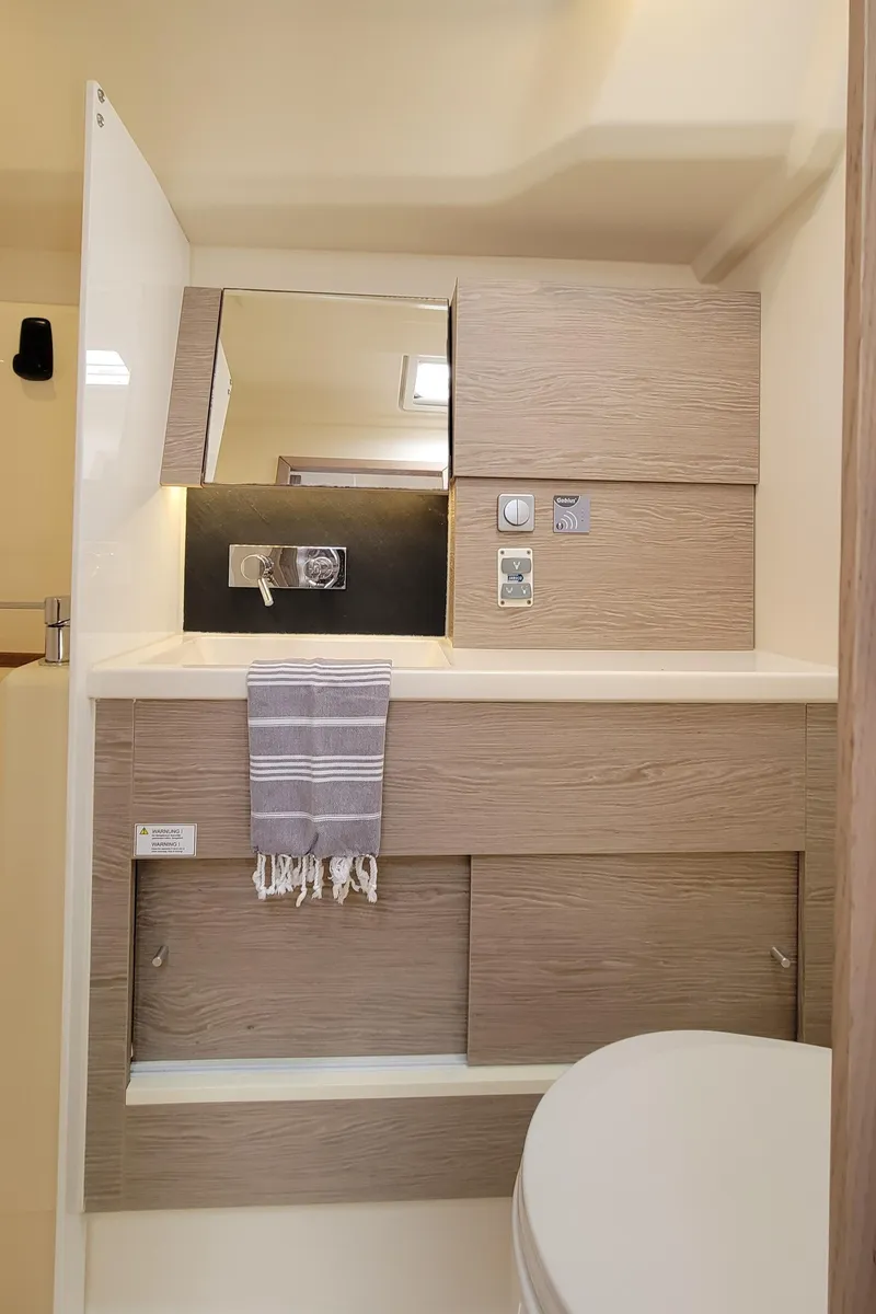 Slide: The Image of Modern bathroom in 2019 Hanse 458 yacht with sleek wood cabinetry and fixtures. - 46