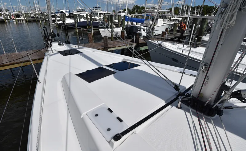 Slide: The Image of 2019 Hanse 458 yacht docked at marina, showcasing sleek deck design. - 7