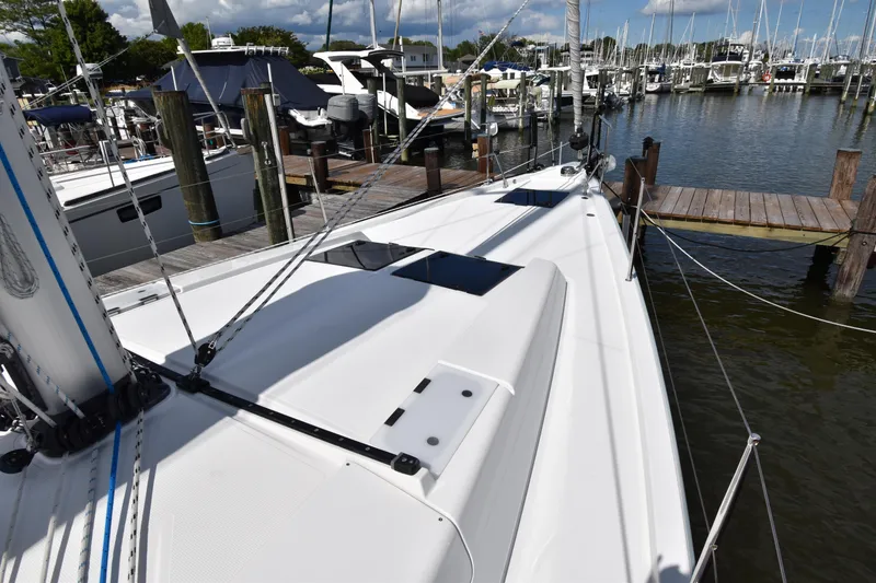 Slide: The Image of 2019 Hanse 458 yacht docked at marina, showcasing sleek deck design. - 8