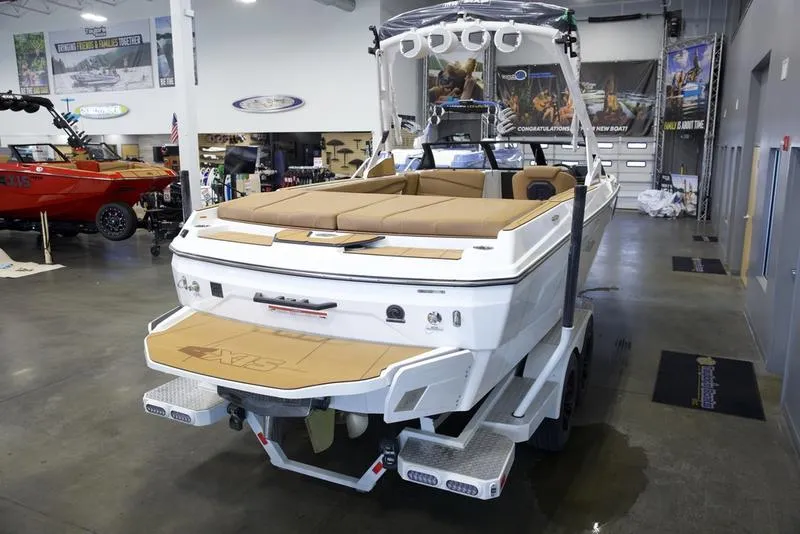 Slide: The Image of 2025 Axis A225 boat in showroom, featuring sleek design and spacious seating. - 10