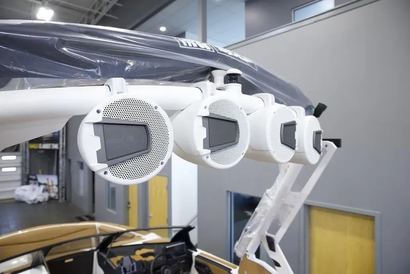 Slide: The Image of Axis A225 2025 boat speakers mounted on a wakeboard tower in a showroom. - 11