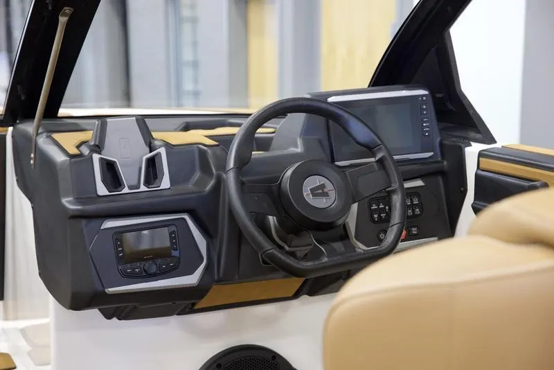 Slide: The Image of 2025 Axis A225 boat dashboard with steering wheel and digital controls. - 14