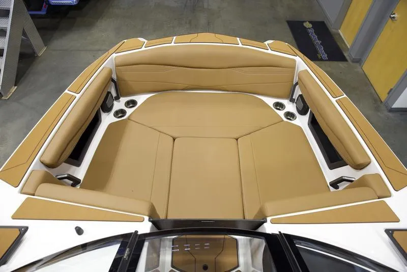 Slide: The Image of 2025 Axis A225 boat interior with tan seating and cup holders. - 17