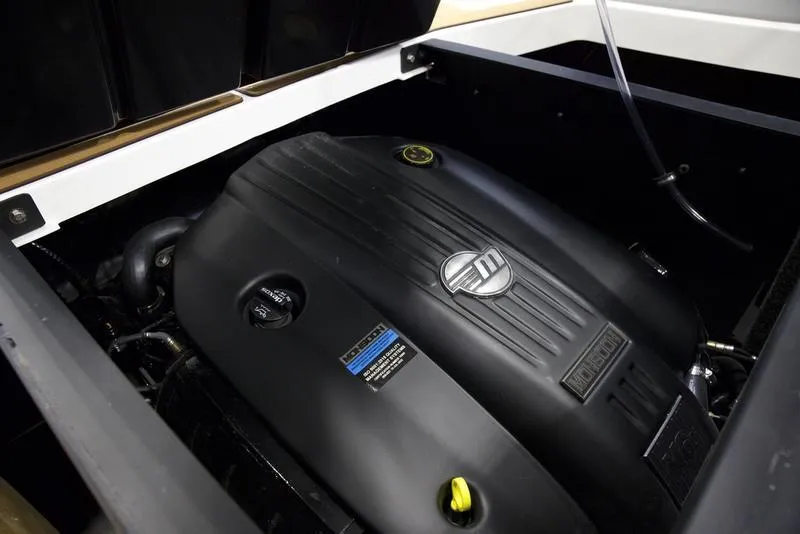 Slide: The Image of 2025 Axis A225 engine compartment with sleek black cover and visible branding. - 2