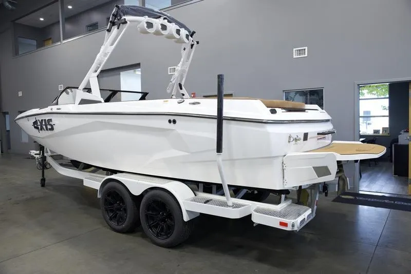 Slide: The Image of 2025 Axis A225 boat on trailer in showroom, side view. - 4