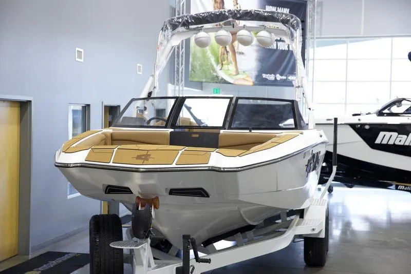 Slide: The Image of 2025 Axis A225 boat displayed indoors on a trailer. - 8