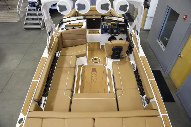 Slide: The Image of 2025 Axis A225 boat interior with tan seating and modern dashboard. - 9