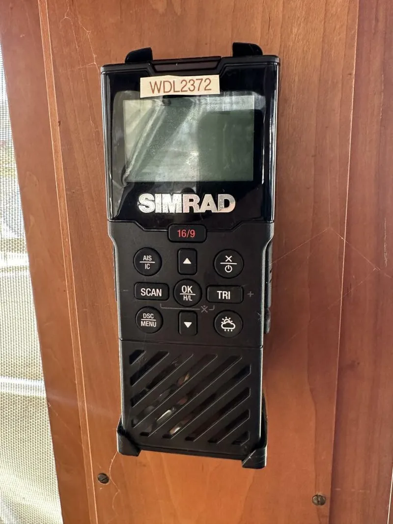 Slide: The Image of Simrad marine radio on 2003 Sabre 36 Fly Bridge Sedan, mounted on wooden panel. - 11