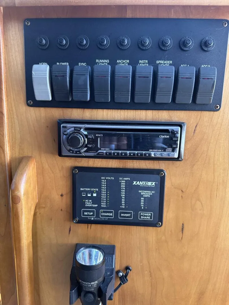 Slide: The Image of Control panel of 2003 Sabre 36 Fly Bridge Sedan with switches and audio system. - 15