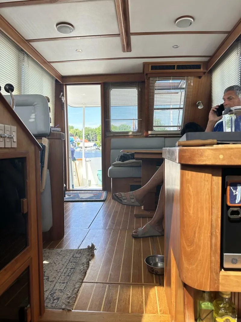 Slide: The Image of Interior of 2003 Sabre 36 Fly Bridge Sedan with wood finish and seated person. - 21