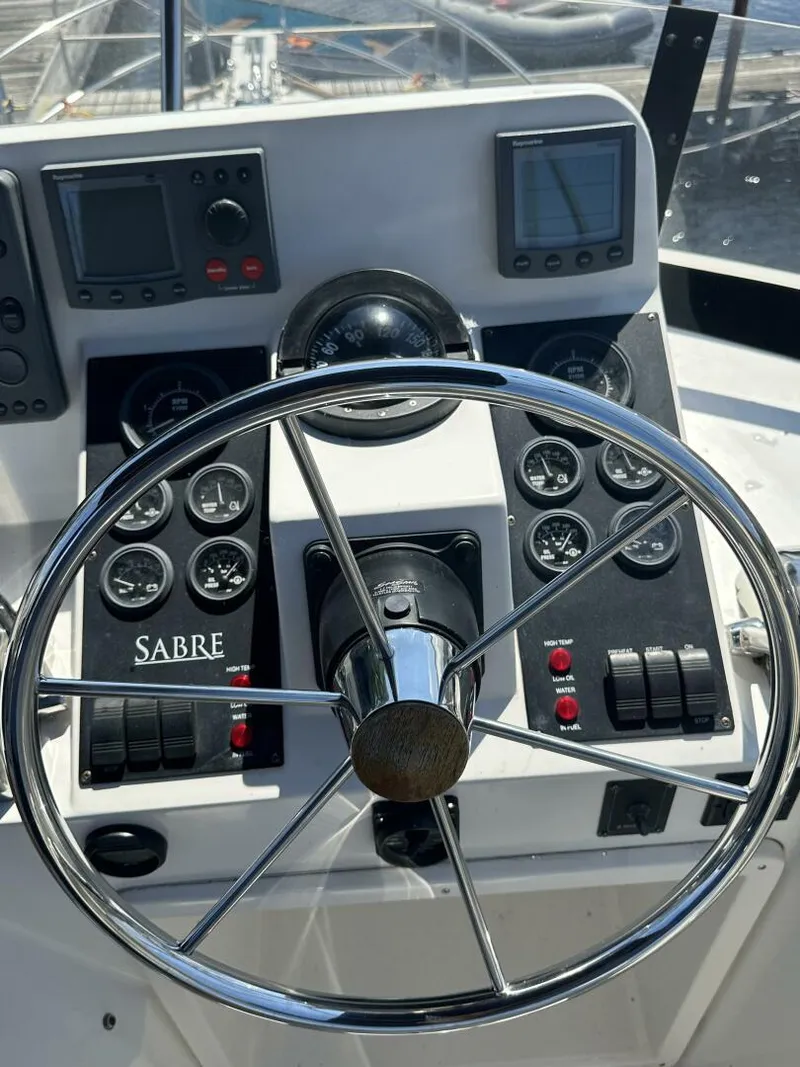 Slide: The Image of Steering wheel and dashboard of 2003 Sabre 36 Fly Bridge Sedan boat. - 23