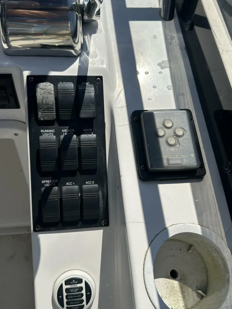 Slide: The Image of Control panel of 2003 Sabre 36 Fly Bridge Sedan with switches and cup holder. - 24