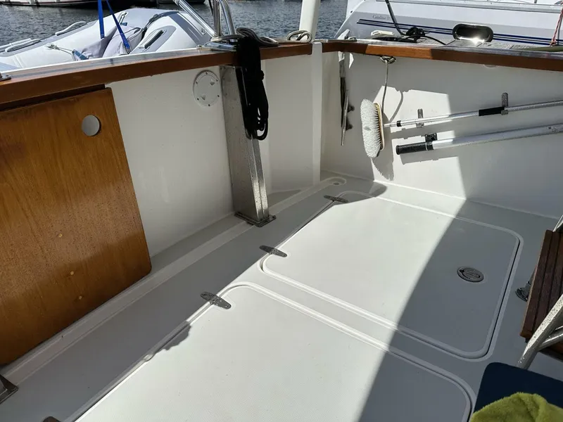 Slide: The Image of 2003 Sabre 36 Fly Bridge Sedan boat deck with clean white surface and wooden accents. - 34